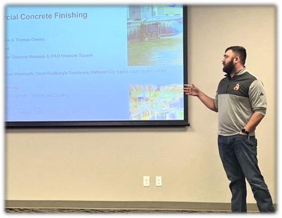 A person standing in front of a projector screen

AI-generated content may be incorrect.